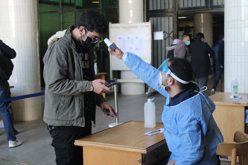 Strict precautionary measures before a building entry, temperature screening, face masks, hand gels stock photography