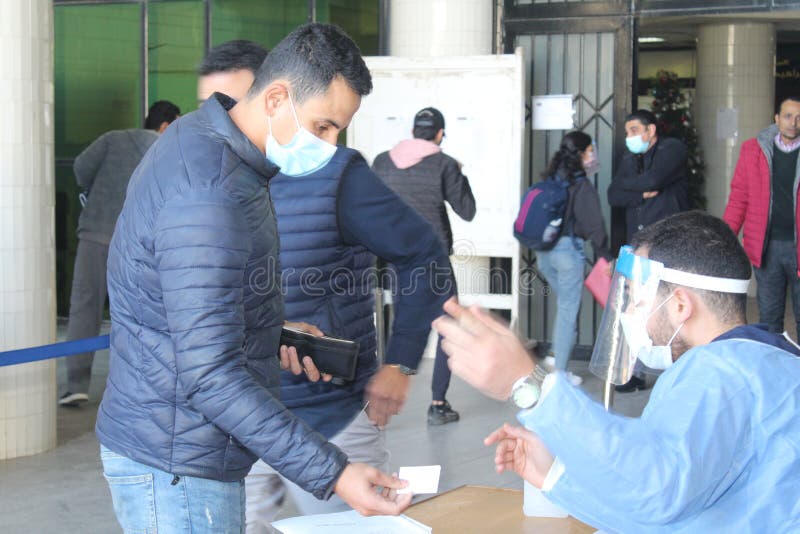 Strict precautionary measures before a building entry, temperature screening, face masks, hand gels stock images