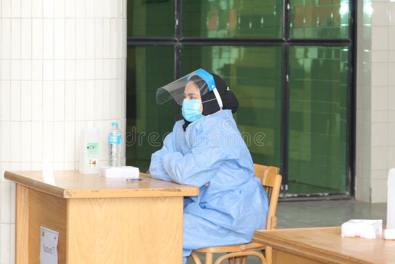 Strict precautionary measures before a building entry, temperature screening, face masks, hand gels royalty free stock photography