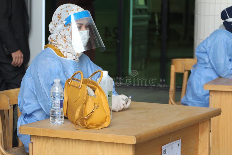 Strict precautionary measures before a building entry, temperature screening, face masks, hand gels royalty free stock photography