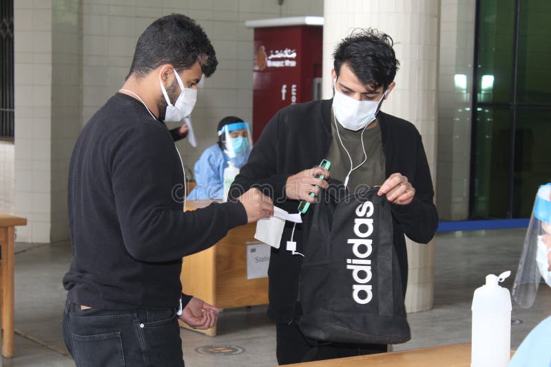 Strict precautionary measures before a building entry, temperature screening, face masks, hand gels royalty free stock image