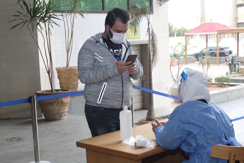 Strict precautionary measures before a building entry, temperature screening, face masks, hand gels, checking covid-19 vaccination certificate amid coronavirus global crisis epidemic outbreak