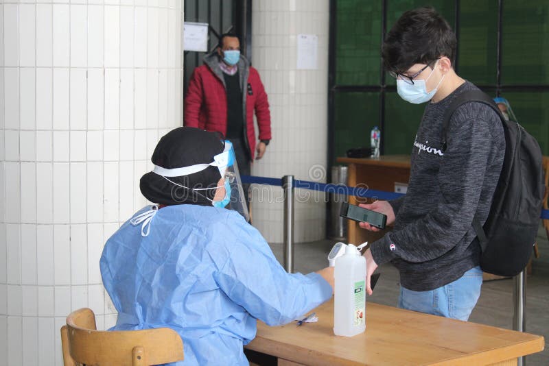 Strict precautionary measures before a building entry, temperature screening, face masks, hand gels stock photos