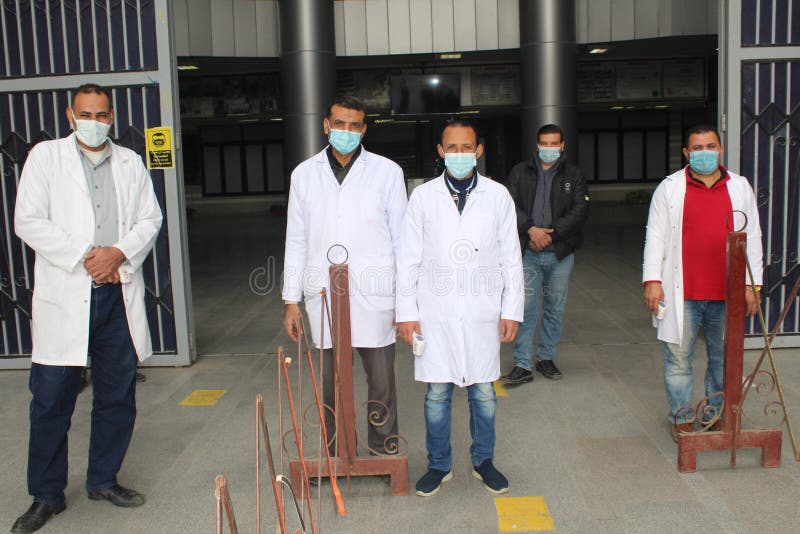 Strict precautionary measures before a building entry, temperature screening, face masks, hand gels stock images