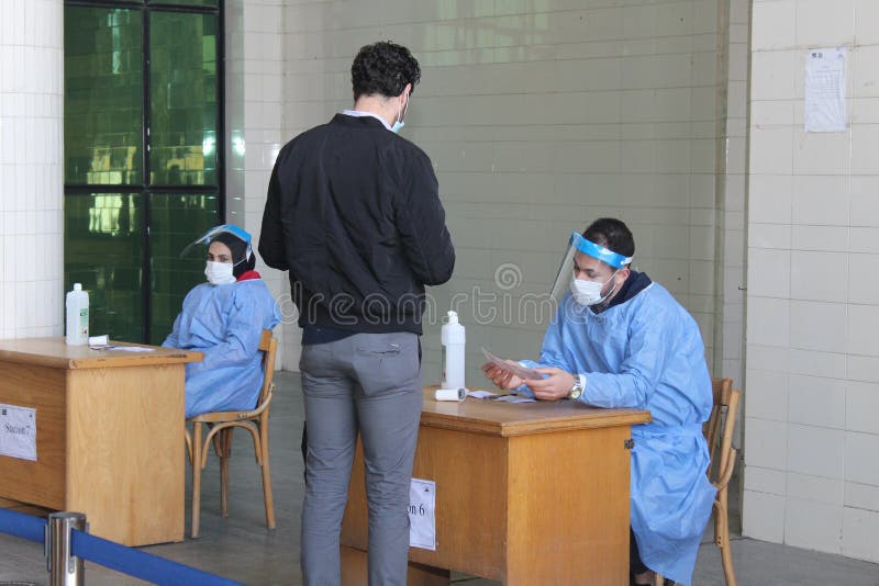 Strict precautionary measures before a building entry, temperature screening, face masks, hand gels stock photos