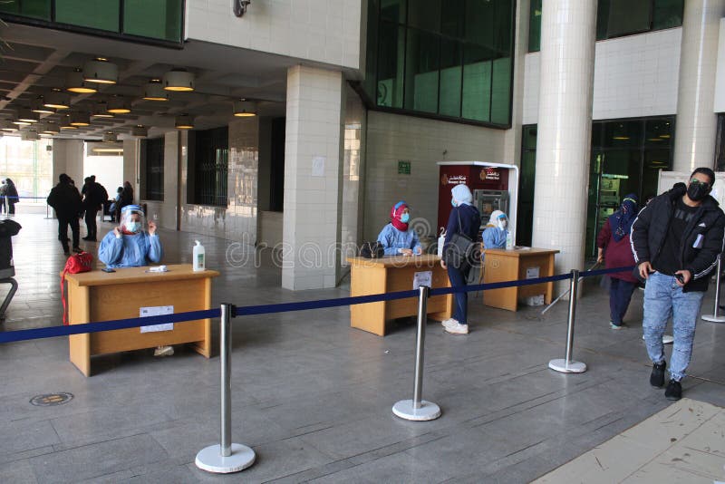 Strict precautionary measures before a building entry, temperature screening, face masks, hand gels royalty free stock photography