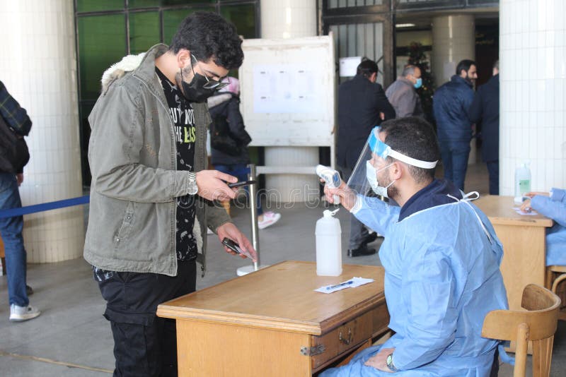 Strict precautionary measures before a building entry, temperature screening, face masks, hand gels stock image