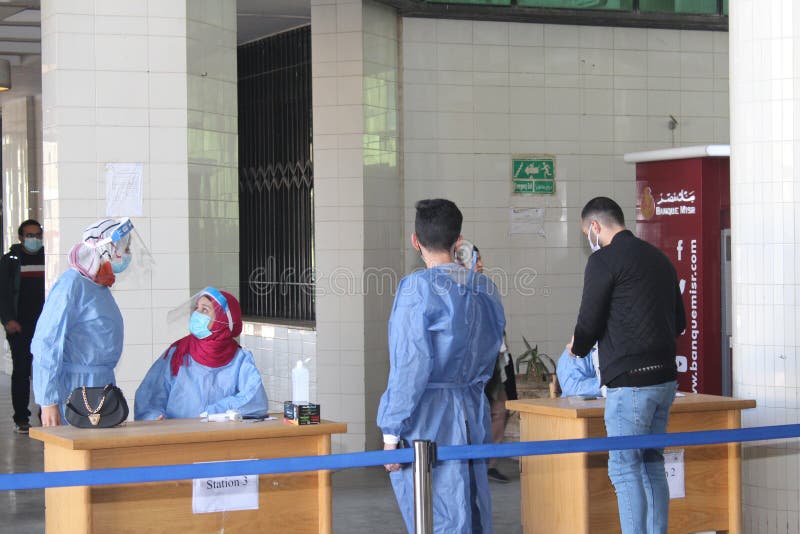 Strict precautionary measures before a building entry, temperature screening, face masks, hand gels stock images