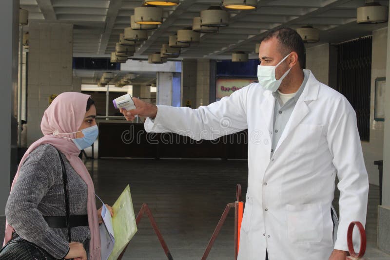 Strict precautionary measures before a building entry, temperature screening, face masks, hand gels royalty free stock photography