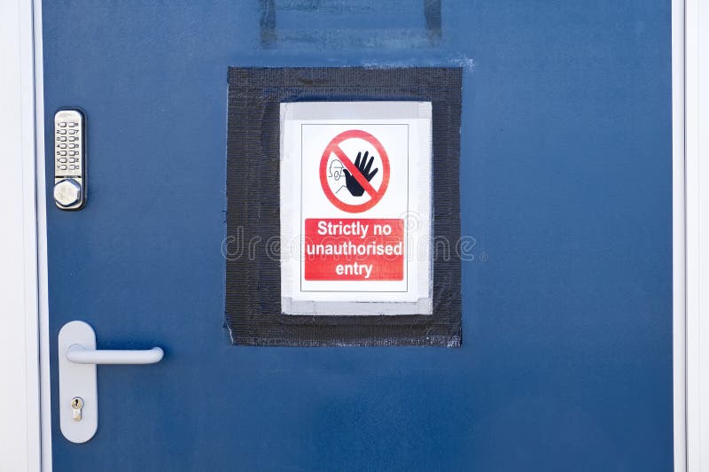 Strictly no unauthorised access sign at construction site security door royalty free stock image