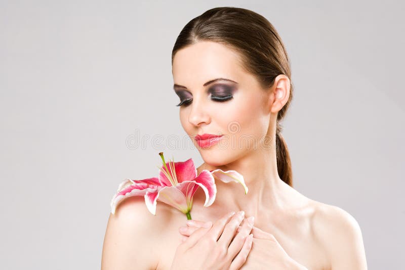 Striking brunette beauty with colorful lily.