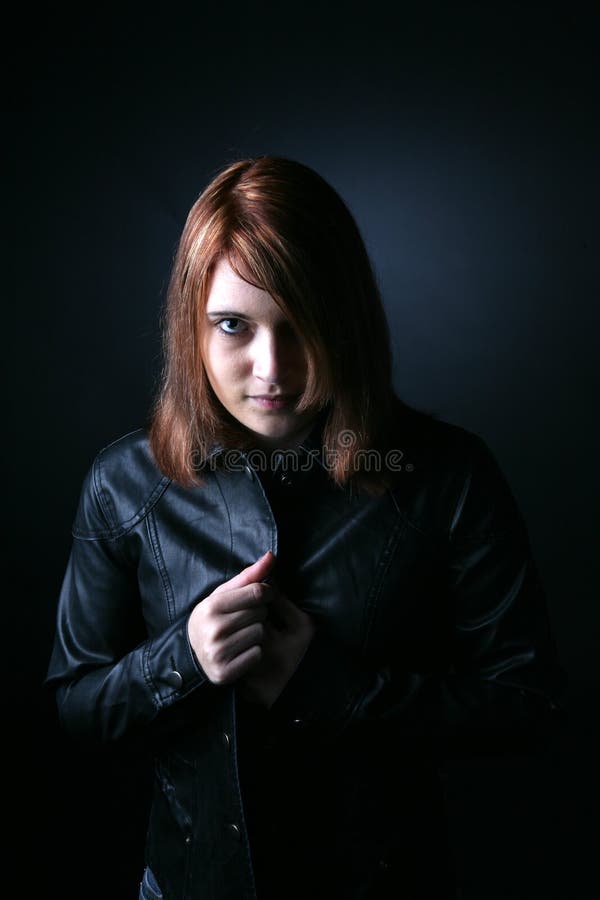 Striking red haired teen in black leather