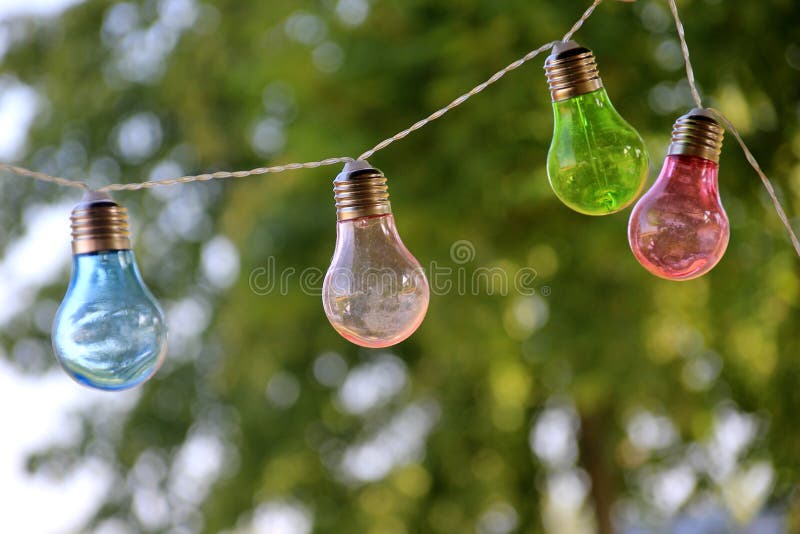 A String of Colored Electric Lights on a Landscape Background Stock