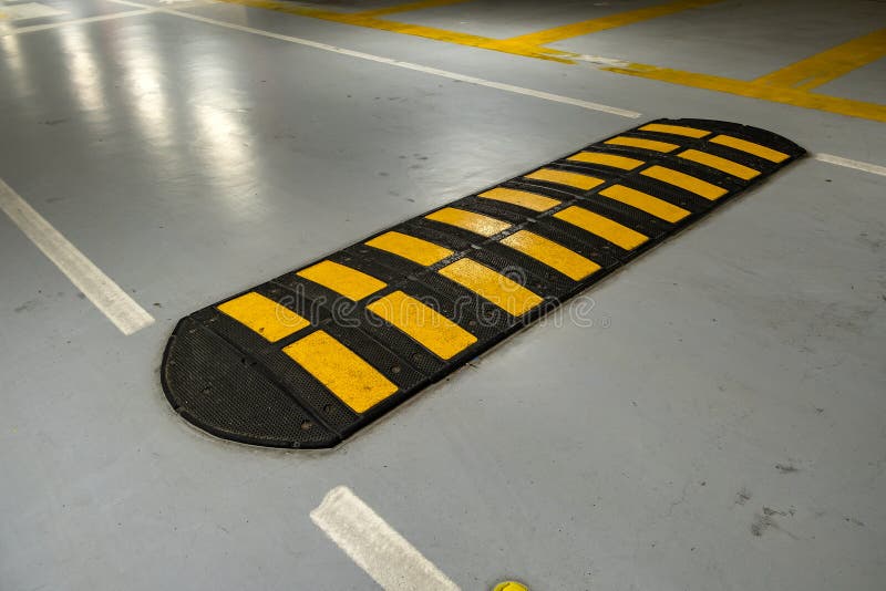 Striped Black and Yellow Speed Bump on a Road Stock Photo Image of