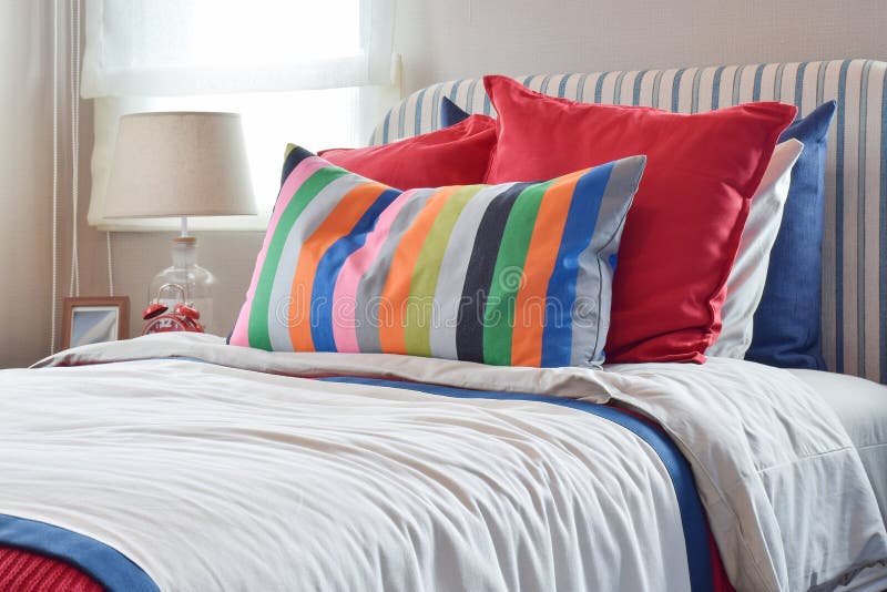 Striped Headboard with Colourfull Pillows and Striped Pillow on White