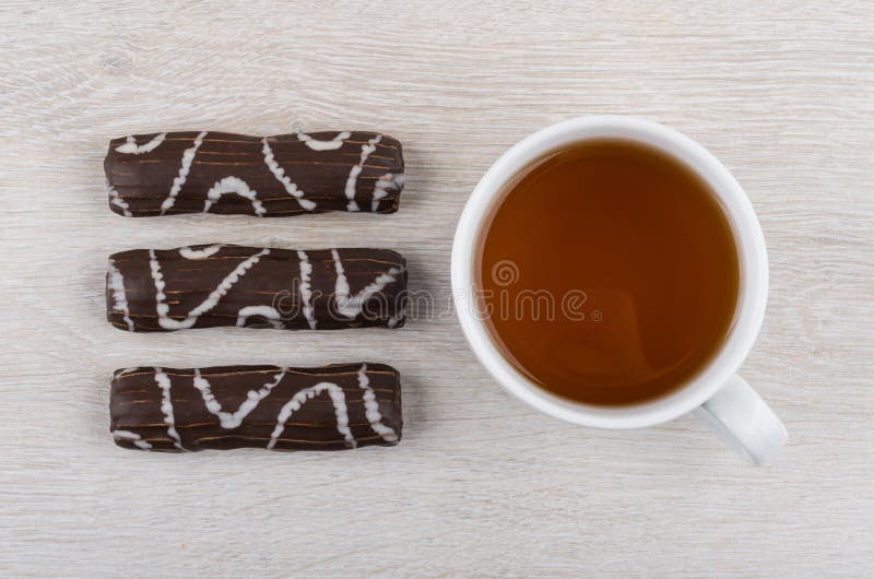 Striped Marshmallow in Chocolate and Cup of Tea on Table Stock Photo
