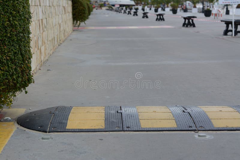 Striped Rubber Sleeping Policeman on Asphalt Road Stock Photo Image