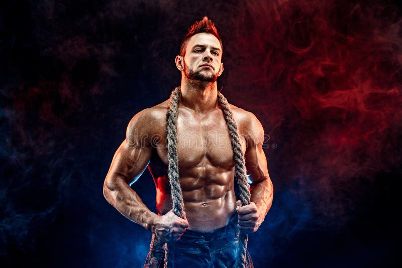 Strong athletic man with naked body in military pants and rope on neck black stock images Strong athletic man with naked body in military pants and rope on neck black stock images