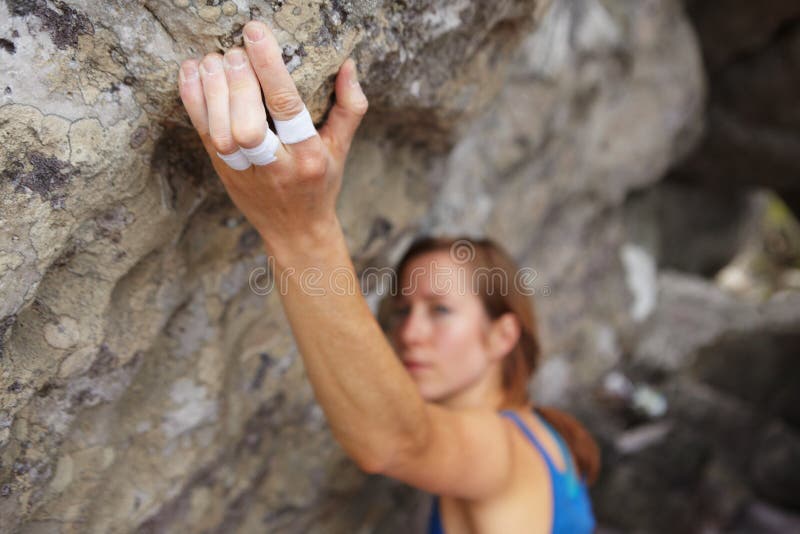 Strong Fingers. a Rock Climber Trying To Get Her Grip. Stock Photo