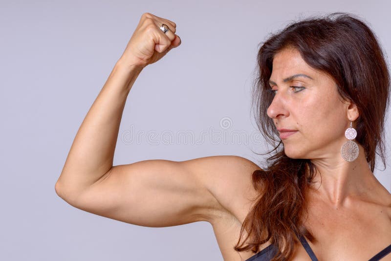 Fit Female Athlete Showcasing Toned Biceps In A Close-Up Shot