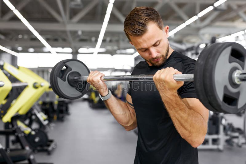 Strong fit caucasian muscular man with big muscles doing barbell weight lifting cross training, bodybuilding concept. Strong fit caucasian muscular man with big muscles doing barbell weight lifting cross training, bodybuilding concept