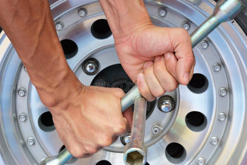 Strong hand try to remove the nut of wheel