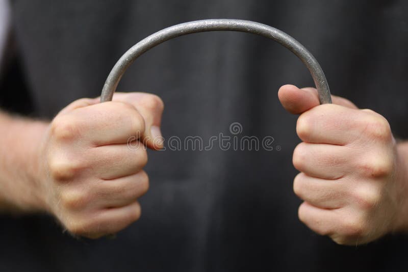 Strong Hands Bend a Metal Rod Stock Photo Image of cement