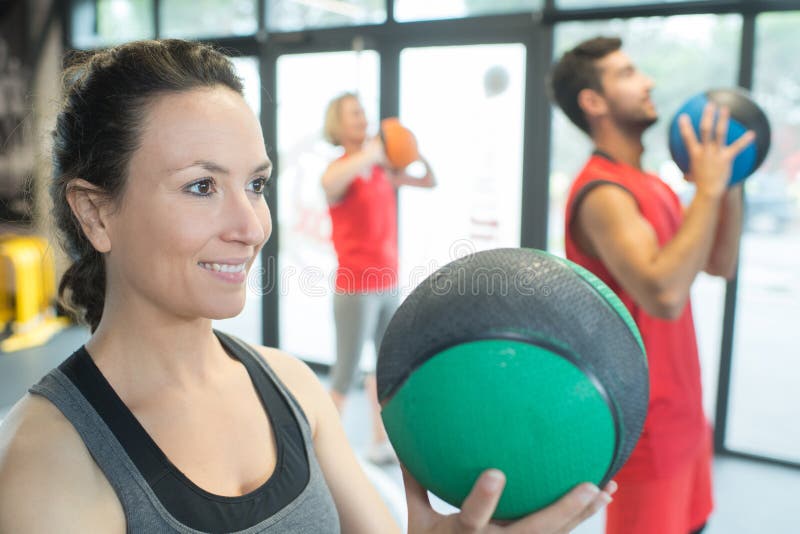 Strong healthy woman holding heavy medicine ball in gym workout royalty free stock images Strong healthy woman holding heavy medicine ball in gym workout royalty free stock images