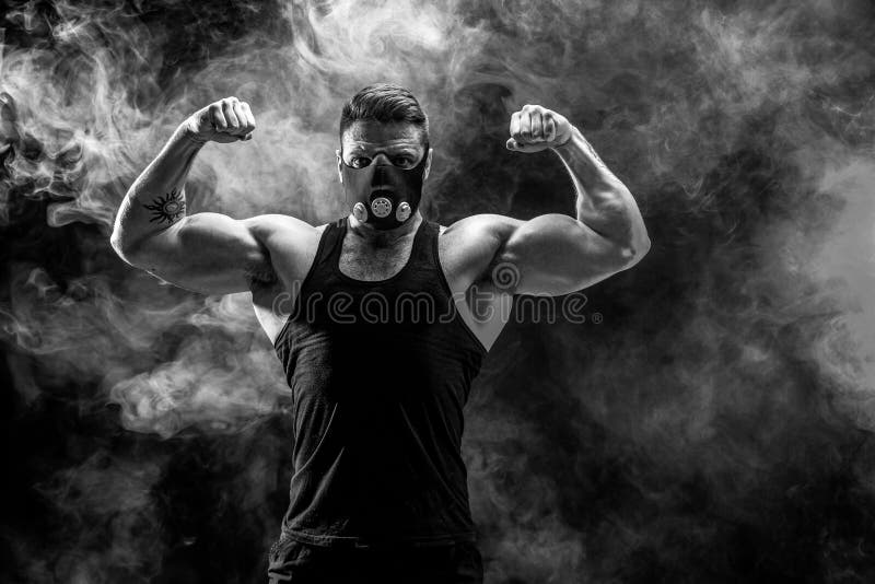 Strong Male Athlete in a Black Training Mask on a Black Background Stock Image Image of
