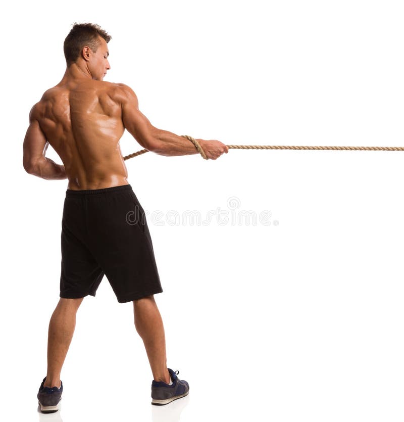 Caucasian strong man pulling rope, cross training gym Stock Photo