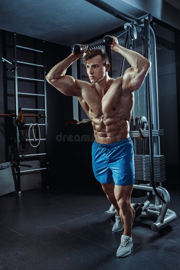 Strong Muscular Bodybuilder Doing Exercise in the Gym. Part of Fitness