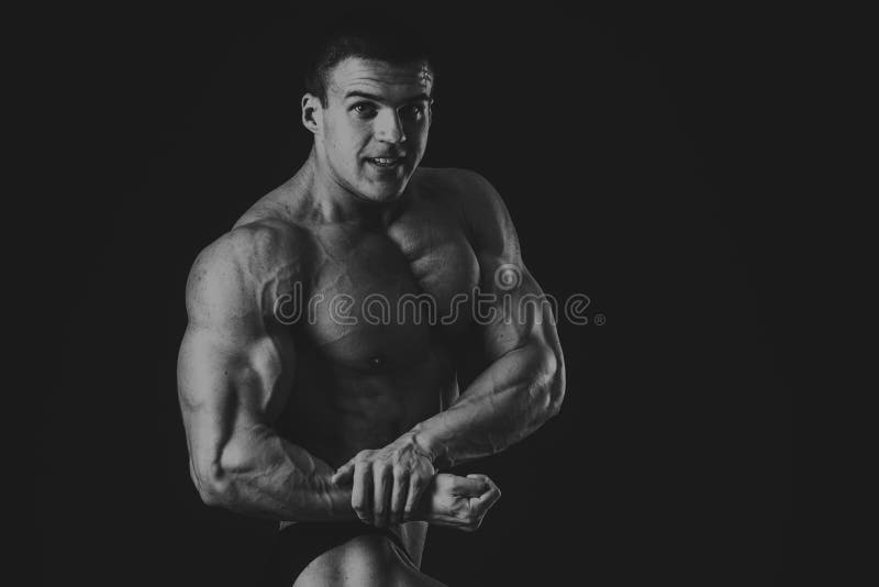 Strong, Muscular Guy on a Black Background Stock Photo - Image of bicep ...