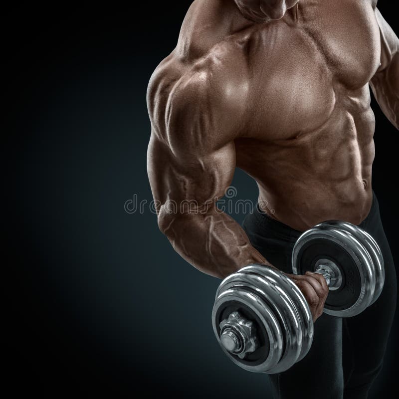 Closeup of a handsome power athletic guy male bodybuilder doing exercises with dumbbell. Fitness muscular body on dark background. Closeup of a handsome power athletic guy male bodybuilder doing exercises with dumbbell. Fitness muscular body on dark background.