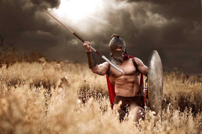 Strong Spartan warrior in battle dress with a shield and a spear