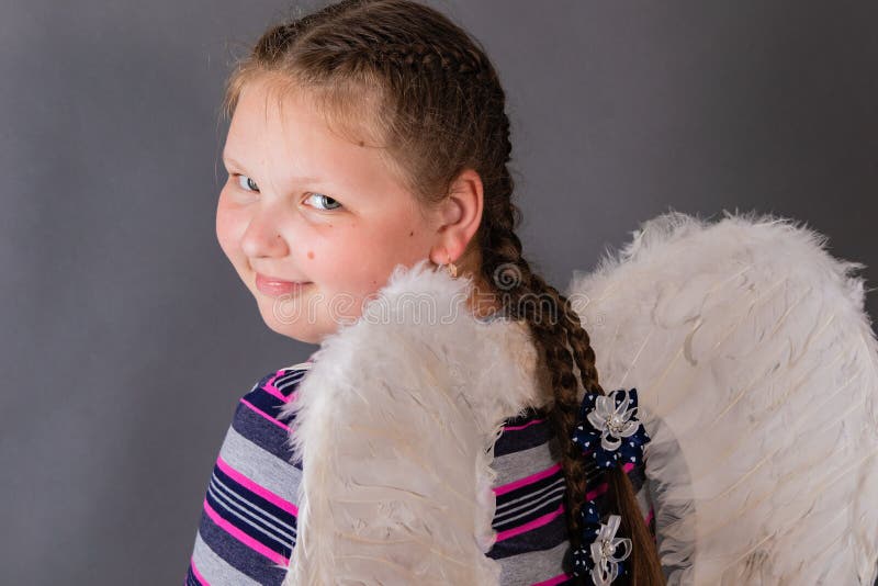 Strong smiling angel girl with wings royalty free stock photography Strong smiling angel girl with wings royalty free stock photography
