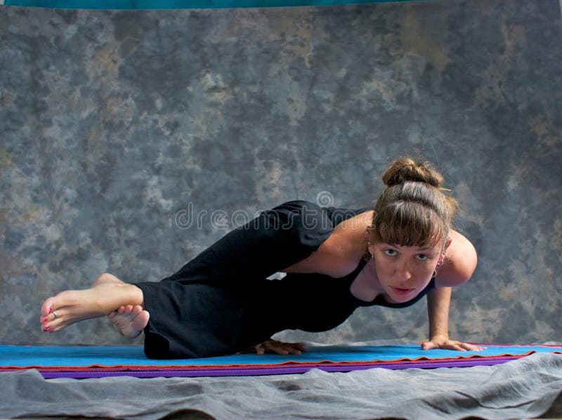 Strong woman doing yoga sage pose