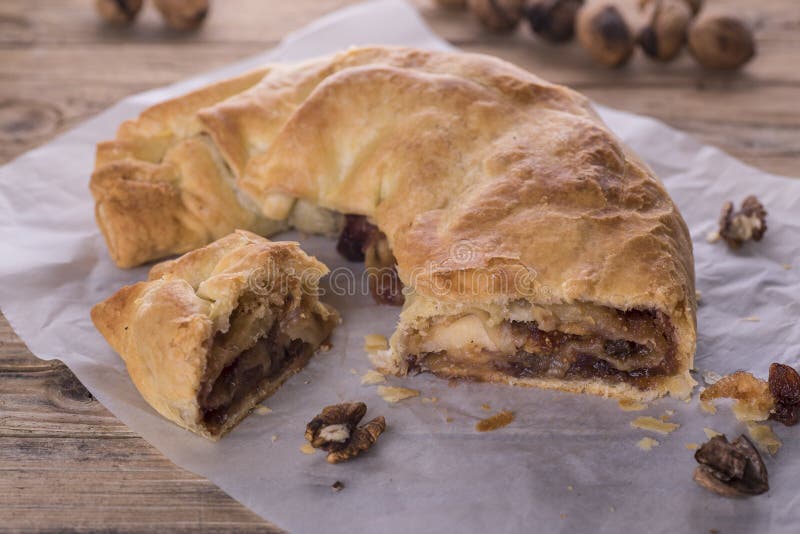 Strudel, sweet puff pastry rolled stuffed with jam, dried fruit, nuts and apples