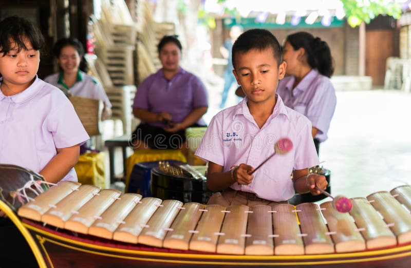 Strumenti musicali tailandesi del gioco degli studenti fotografie stock Strumenti musicali tailandesi del gioco degli studenti fotografie stock