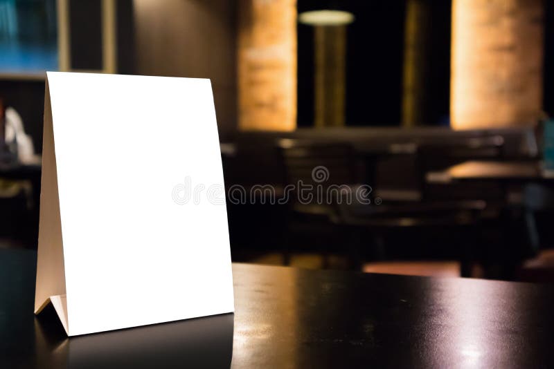 Mockup empty white label menu frame on table with cafe restaurant interior background. Mockup empty white label menu frame on table with cafe restaurant interior background