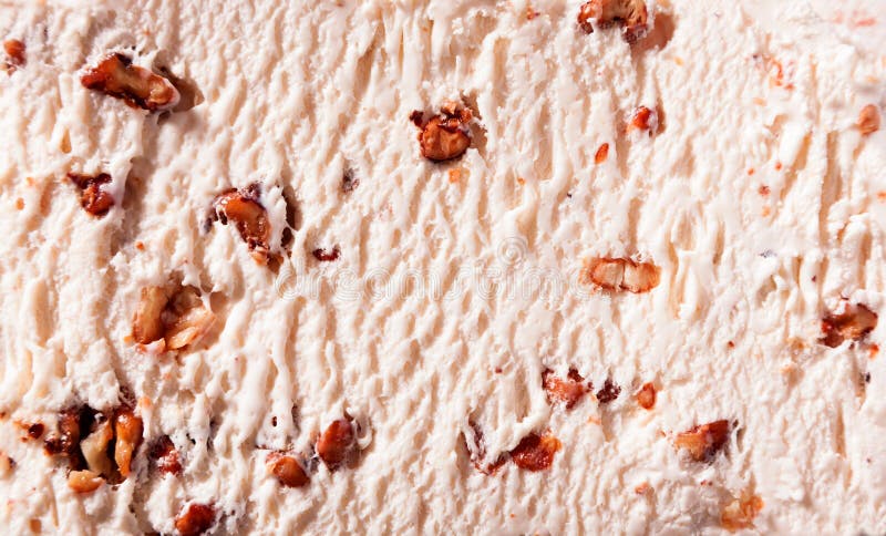 Walnut ice-cream background texture with chopped fresh nuts in a close up full frame view of the surface from above. Walnut ice-cream background texture with chopped fresh nuts in a close up full frame view of the surface from above