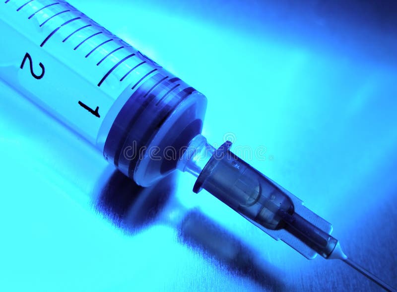 Syringe close-up toning in blue. Syringe close-up toning in blue