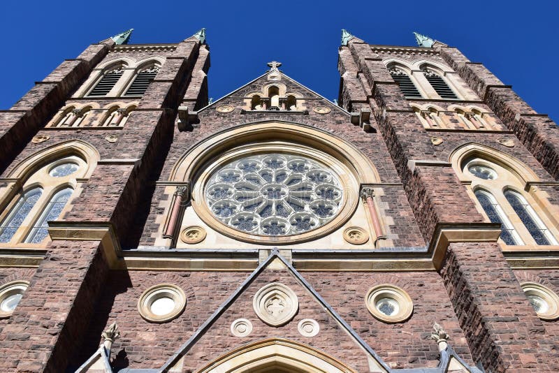 Facade close-up of St Peter's Cathedral Basilica in London, Ontario. Built in the 1880s in the 13th century French Gothic style, the Cathedral features two massive bell towers and a rose window made in Innsbruck, Austria. This historic church was designated a minor Basilica by the Vatican in 1961 and is designated as an Ontario heritage building. Facade close-up of St Peter's Cathedral Basilica in London, Ontario. Built in the 1880s in the 13th century French Gothic style, the Cathedral features two massive bell towers and a rose window made in Innsbruck, Austria. This historic church was designated a minor Basilica by the Vatican in 1961 and is designated as an Ontario heritage building.