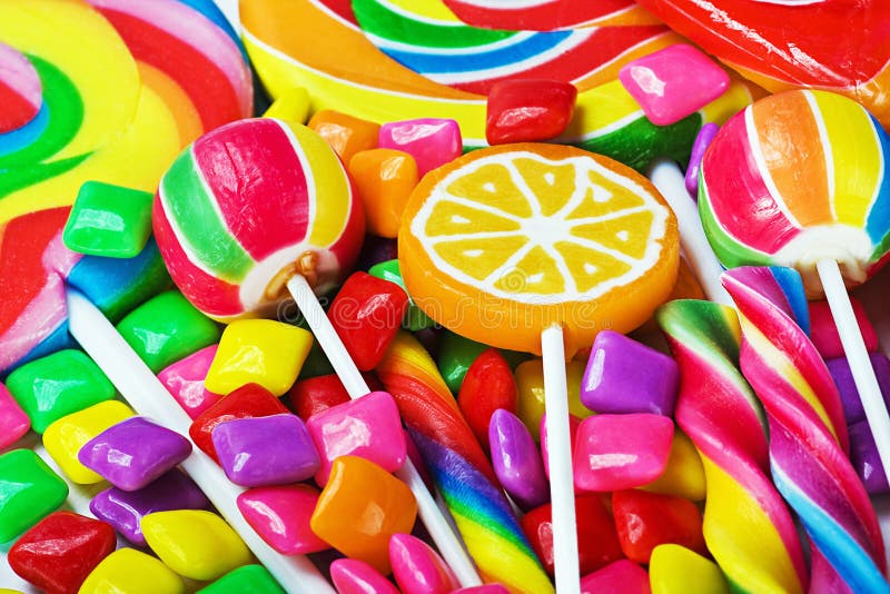 Multicolored lollipops, candy and chewing gum background. Multicolored lollipops, candy and chewing gum background