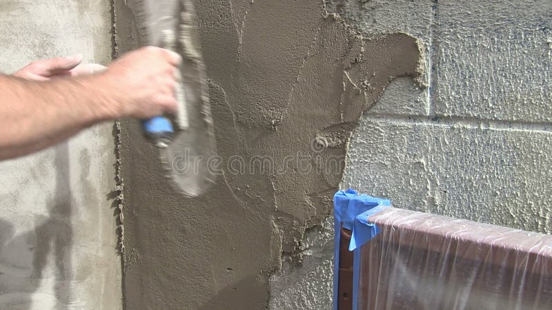 stucco application wall close up video man putting cinder block 43644736