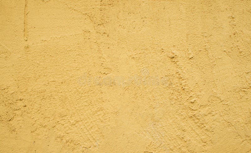 The empty yellow stucco wall texture background. The empty yellow stucco wall texture background