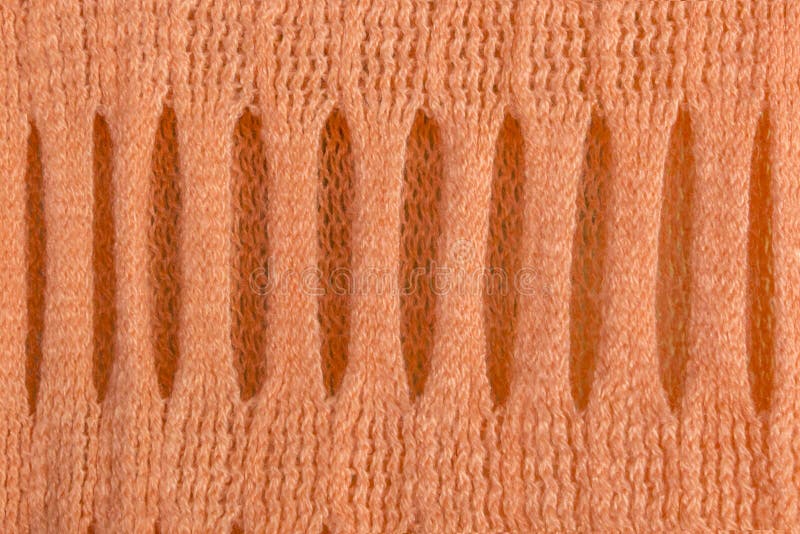 Stucken woolen textur med den härliga holey traceryen av den delikata apelsinen för abstrakta modellbakgrunder royaltyfri fotografi Stucken woolen textur med den härliga holey traceryen av den delikata apelsinen för abstrakta modellbakgrunder royaltyfri fotografi