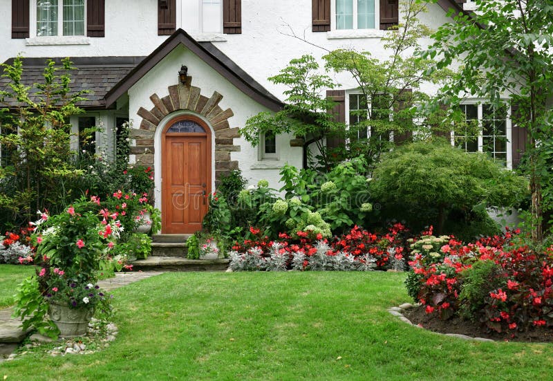 Stuckhaus mit Blumen im Vorgarten lizenzfreie stockfotografie Stuckhaus mit Blumen im Vorgarten lizenzfreie stockfotografie