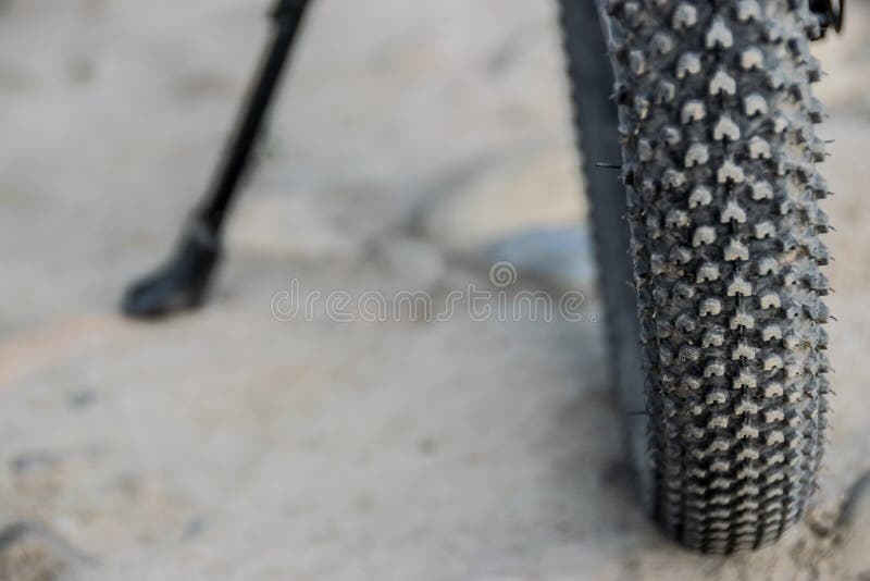 Studded tire of mountain bike, close-up stock photo Studded tire of mountain bike, close-up stock photo
