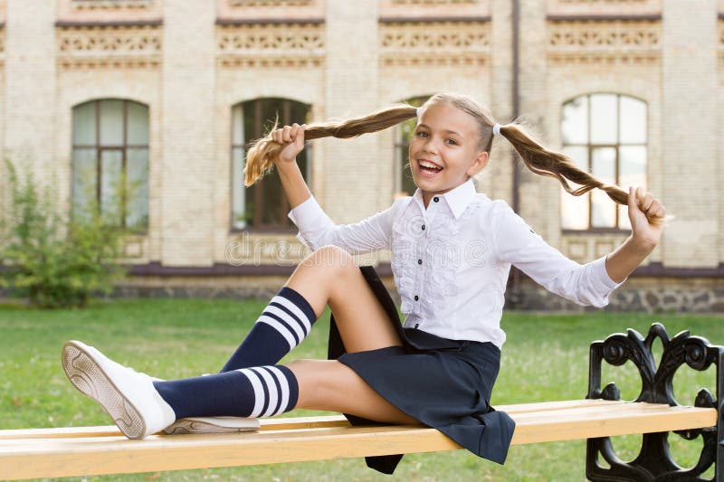 Student adorable child in formal uniform relaxing outdoors. Pleasant minutes of rest. Time to relax and have fun