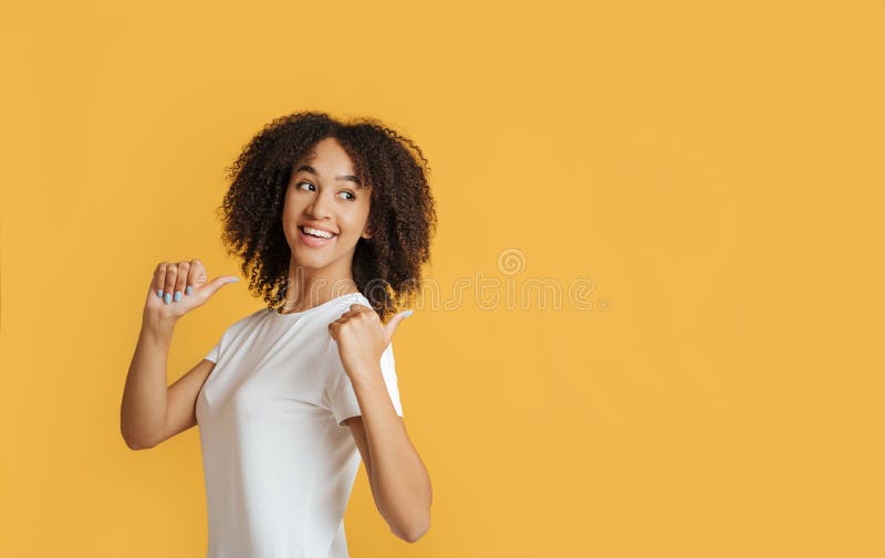 Student, blogger recommends great offer. Happy african american lady with showing thumbs back to free space stock photo